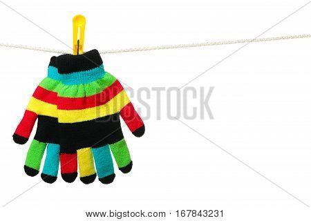 Multicolor striped gloves hanging on the clothesline on white background