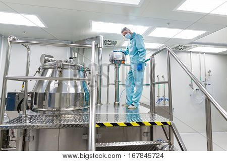 Scientist Look In Steel Tank In Laboratory