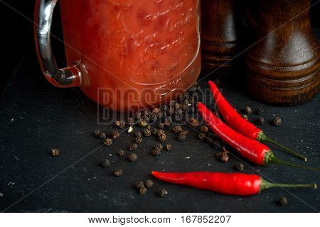 Bloody Mary or Bloody Ceasar with celery in mason jar rimmed with black pepper