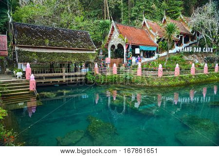 Chiang Mai,Thailand - Jan 15 2017 : Wat Chiangdao Cave surrounded by Turquoise fish pond at Doi Chung mountain