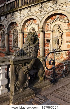 HILLEROD, DENMARK - DECEMBER 27, 2016: Sculpture of lion at the entrance to Frederiksborg Castle. It was built as a royal residence and becoming the largest Renaissance residence in Scandinavia