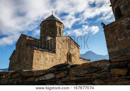 Tsminda Sameba Gergeti Holy Trinity Church close up near the Stepantsminda Kazbegi village Georgia. Georgian landmark and travel destination