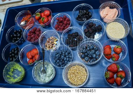 assorted of colorful spices and berries on a black background for cooking
