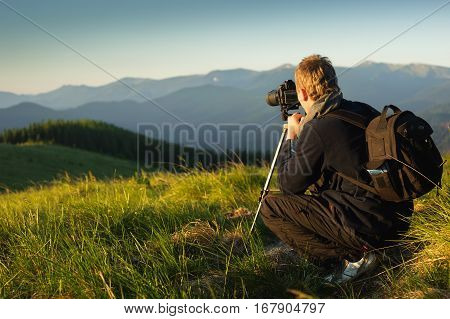 The photographer with camera on a tripod.