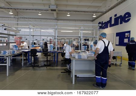 ST. PETERSBURG, RUSSIA - NOVEMBER 2, 2016: People at work in the department of packaging of products of StarLine company. It is one of the leading company on the automotive security market of Russia