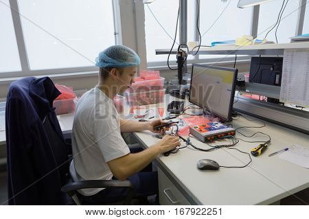 ST. PETERSBURG, RUSSIA - NOVEMBER 2, 2016: People at work on the production site of StarLine company. It is one of the leading company on the automotive security market of Russia