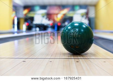 Bowling accessories background. Interior of bowling alley, lane with ball closeup, selective focus