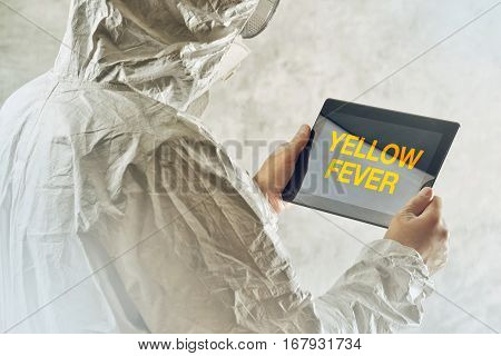 Medical scientist using tablet computer to get informed about yellow fever disease