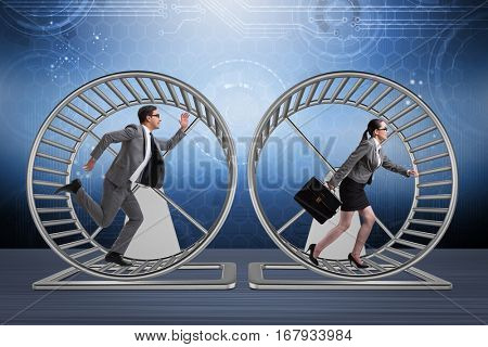 Business concept with pair running on hamster wheel