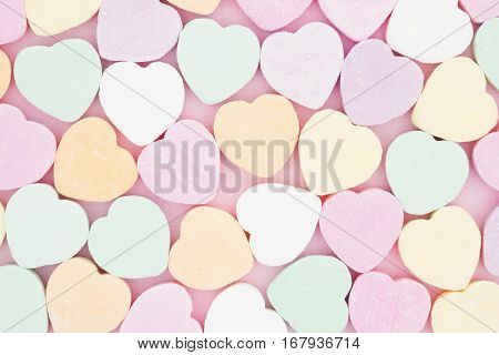 Old fashion pale multi colored candy heart background