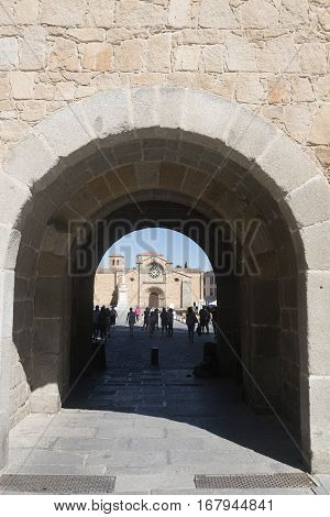 AVILA, SPAIN - JULY 23, 2016: Avila (Castilla y Leon Spain): the Santa Teresa church through an arch with people