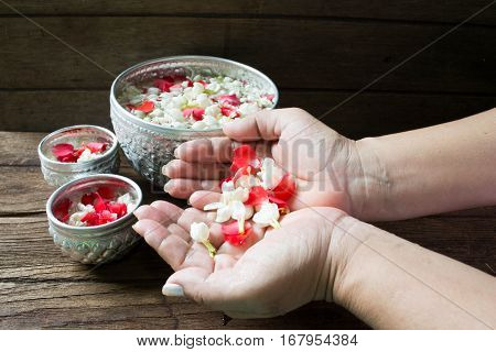 Water in bowl mixed with perfume and flowers corolla for Songkran festival in Thailand.