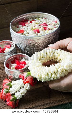 Water in bowl mixed with perfume and flowers corolla for Songkran festival in Thailand.
