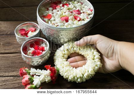 Water in bowl mixed with perfume and flowers corolla for Songkran festival in Thailand.