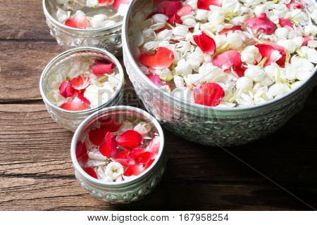 Water in bowl mixed with perfume and flowers corolla for Songkran festival in Thailand.
