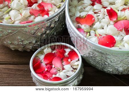 Water in bowl mixed with perfume and flowers corolla for Songkran festival in Thailand.