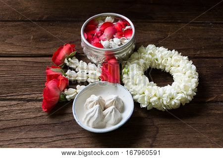 Water in bowl mixed with perfume and flowers corolla for Songkran festival in Thailand.