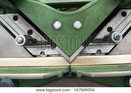 Craftsman working on frame in frameshop. Professional framer hand holding frame angle. Top view.