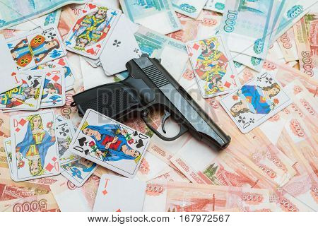 Black Gun Lying On The Big Russian Money And Playing Cards