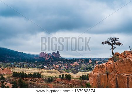 Image of a cloudy landscape with red rock formations.