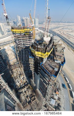 United Arab Emirates, Dubai, 05/21/2015, Damac Towers Dubai by Paramount, construction and building ariel views with cityscape background