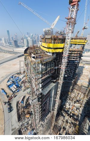 United Arab Emirates, Dubai, 05/21/2015, Damac Towers Dubai by Paramount, construction and building ariel views with cityscape background