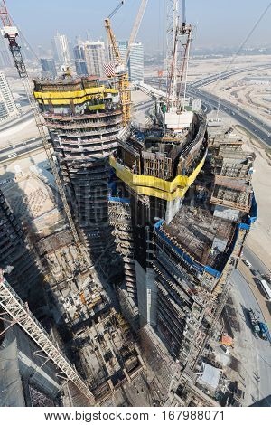 United Arab Emirates, Dubai, 05/21/2015, Damac Towers Dubai by Paramount, construction and building ariel views with cityscape background