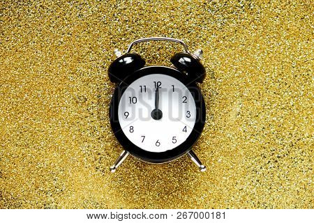 Holiday Coundown Concept. Old Alarm Clock That Shows 12 Am Time Laying On Beautiful Shiny Glossy Gol