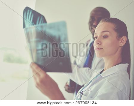 Doctors analyzing an x-ray in a meting. Doctors
