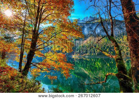 Beautiful View Of Idyllic Colorful Autumn Scenery With Dachstein Mountain Summit Reflecting In Cryst