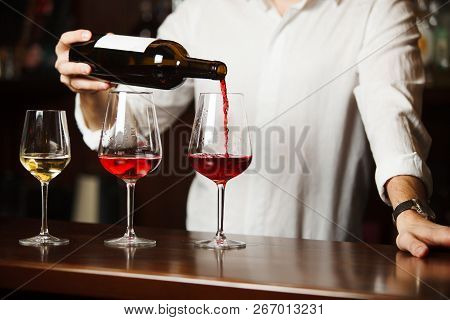 Sommelier Pouring Different Types Of Fine Wine