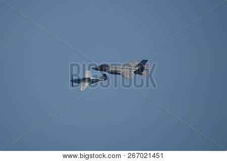 North American P-51 Mustang And Lockheed Martin F-35 Lightning Ii Flying Side By Side In A Heritage 