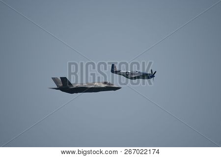 North American P-51 Mustang And Lockheed Martin F-35 Lightning Ii Flying Side By Side In A Heritage 