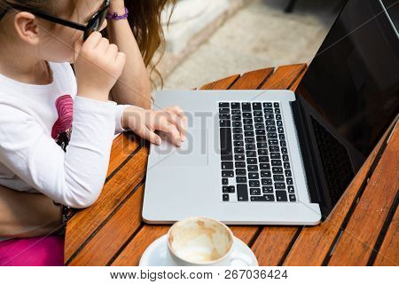 Detail Of Little Girl Surfing On Laptop Trackpad