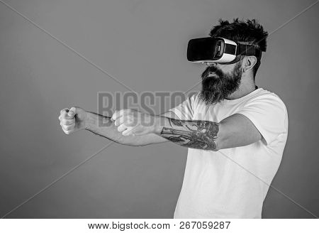 Virtual Racing Concept. Man With Beard In Vr Glasses Driving Car, Red Background. Hipster On Concent