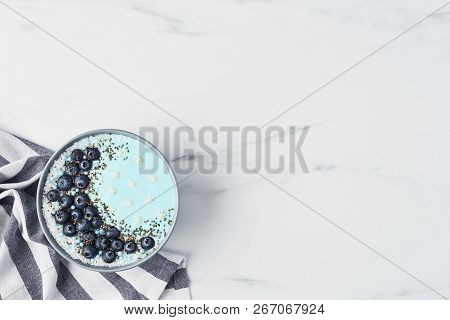 Top View Of Blue Yogurt Smoothie Bowl Made With Blueberry, Coconut Flour, Chia Seeds And Sugar Pearl