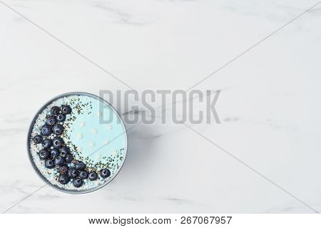 Top View Of Blue Yogurt Smoothie Bowl Made With Blueberry, Coconut Flour, Chia Seeds And Sugar Pearl