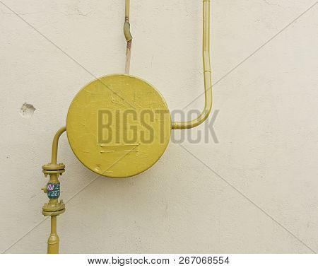 Yellow Gas Pipe On The Background Of A Pink Wall