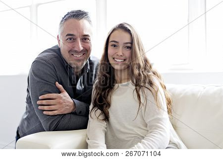 Teenager Girl Sitting On Window With Father
