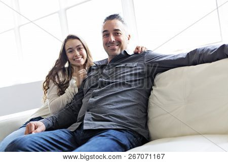Teenager Girl Sitting On Window With Father