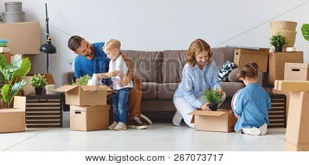 Appy Family Mother Father And Children Move To A New Apartment And Unpack Boxes