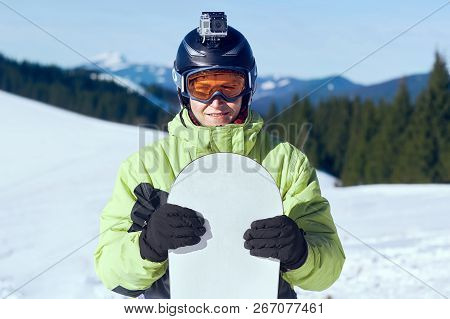Snowboarder With Action Camera On A Helmet. Close Up Portrait Of Snowboarder In Carpathian Mountains