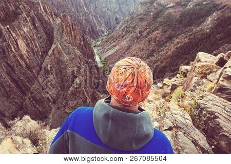 Tourist on the granite cliffs of the Black Canyon of the Gunnison, Colorado, USA