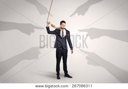 Young businessman trying to suicide with pointing hands concept