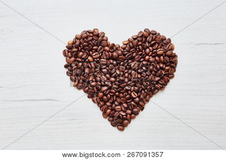Heart From Coffee Beans On Wooden Background