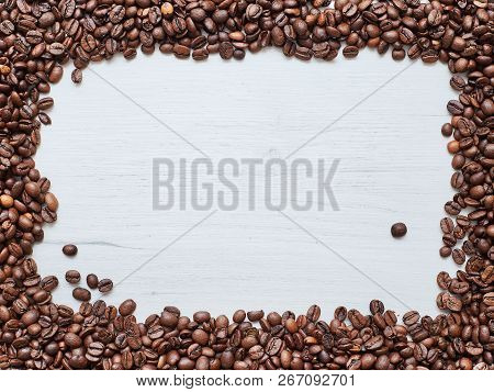 Square Frame Of Coffee Beans On A Wooden Table