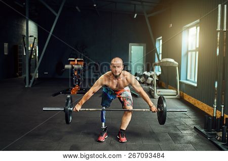 Sportsman With Prosthesis Working Out In Gym
