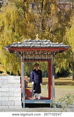 THIMPHU, BHUTAN - DEC 3, 2017: Royal honour guard on duty in front of the Tashichho Dzong, Thimphu, Bhutan. This is Buddhist Monastery and Fortress where the civil government office located.