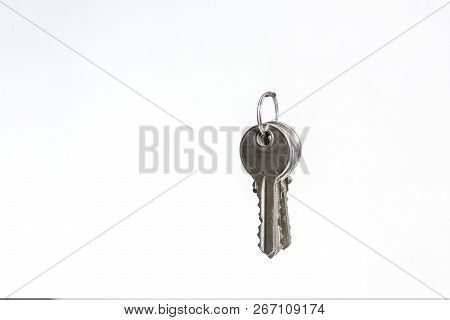 A Bunch Of Keys Hanging On A Carnation On A White Wall In The House