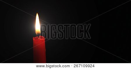 Red Candle Brightly Lit Black Background Close-up